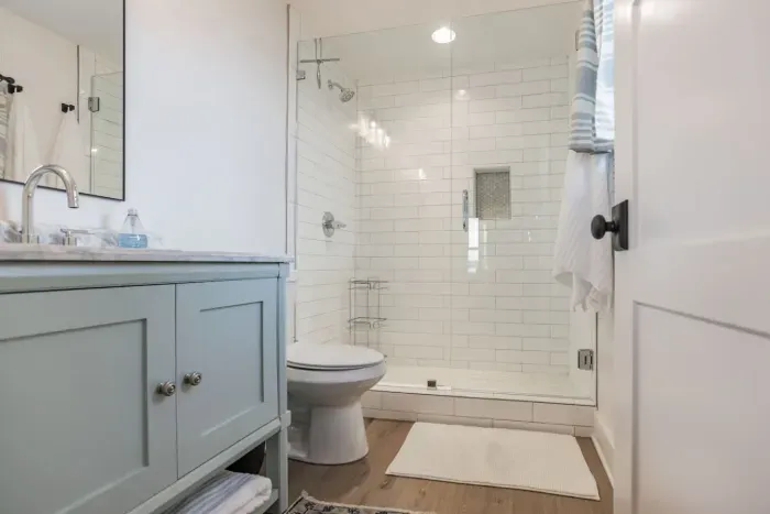 Private ensuite bathroom connected to the downstairs queen bedroom. Custom tile shower.