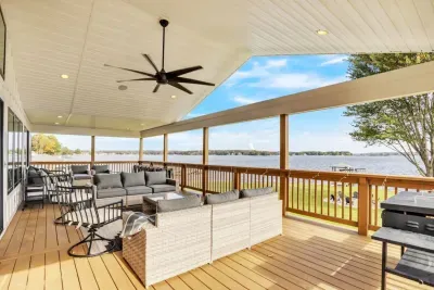 Outdoor porch with built in speakers, ample seating, and a Blackstone Griddle & BBQ grill