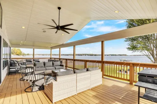 Outdoor porch with built in speakers, ample seating, and a Blackstone Griddle & BBQ grill