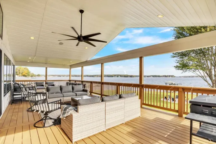Outdoor porch with built in speakers, ample seating, and a Blackstone Griddle.
