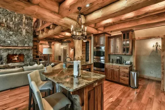 Designed for connection, this spacious kitchen offers a large stone island, custom cabinetry, and seamless flow into the great room—ideal for shared meals and memorable evenings.