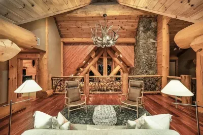 The upstairs common area provides a comfortable gathering space between bedrooms, with cozy seating and rustic elegance—great for kids, games, or late-night conversations.