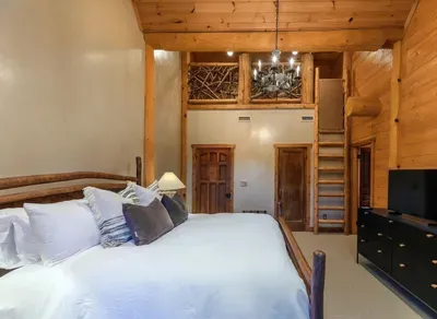 Unwind in this spacious guest room with a king bed, soft lighting, and private outdoor access—perfect for quiet mornings and restful nights.