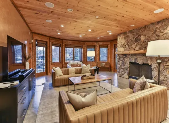 This comfortable lower-level living room offers soft lighting, and ample seating—creating a relaxed retreat for downtime, games, or movie nights.