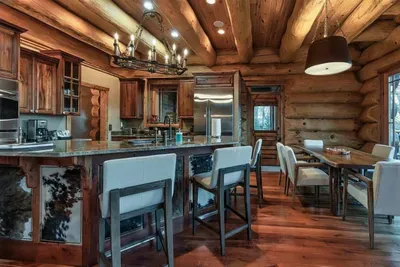 Designed for connection, this spacious kitchen offers a large stone island, custom cabinetry, and seamless flow into the great room—ideal for shared meals and memorable evenings.