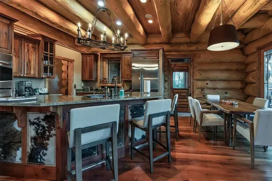 Designed for connection, this spacious kitchen offers a large stone island, custom cabinetry, and seamless flow into the great room—ideal for shared meals and memorable evenings.