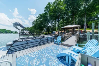 Private dock with pontoon boat tied up.  Boat is not included, but we do provide info to reserve your boat rental.