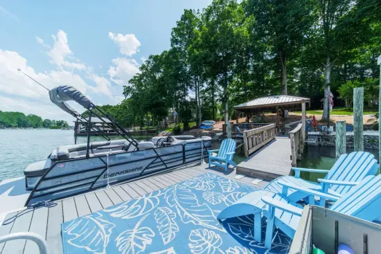 Private dock with pontoon boat tied up.  Boat is not included, but we do provide info to reserve your boat rental.