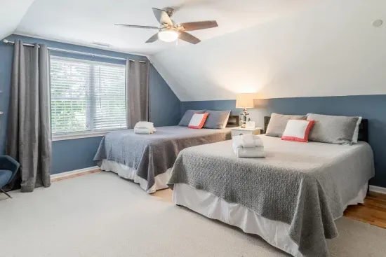 The other upstairs bedroom has two (2) Queen-sized beds with tons of room to share, with closet, fan and TV.