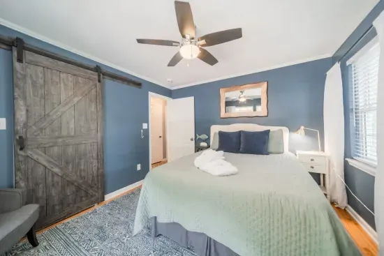 Relax and unwind in our main floor primary bedroom, with closet, fan and TV for your private use.
