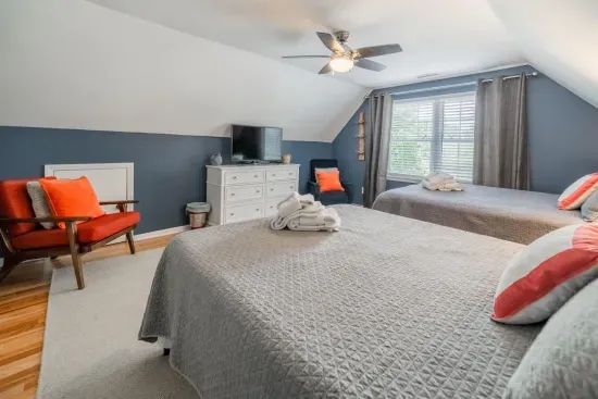 The other upstairs bedroom has two (2) Queen-sized beds with tons of room to share, with closet, fan and TV.