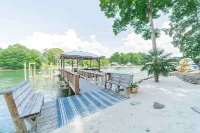 The dock connects to the sand beach with available seating.