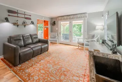 Lounge around in the living room with view of the deck.  Stay on top of your favorite shows using our large TV.