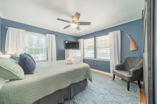 Relax and unwind in our main floor primary bedroom, with closet, fan and TV for your private use.