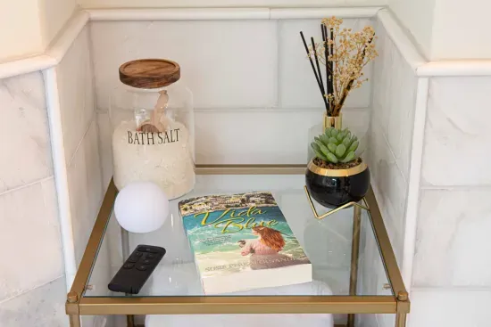 Near the tub are bath salts and great reading.