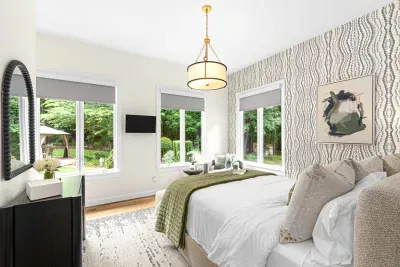 Secondary bedroom with Queen size bed and views to the beautiful back yard.  Seating area to enjoy your morning coffee.