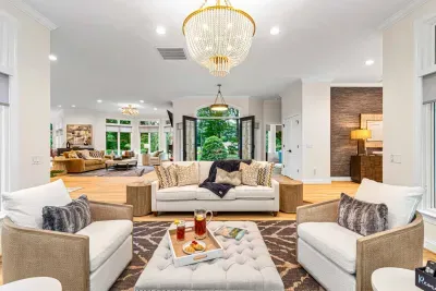 Our sunroom features lots of seating and is surrounded by windows.