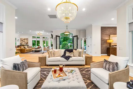 Our sunroom features lots of seating and is surrounded by windows.