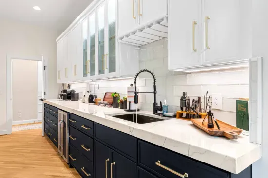 Behind the kitchen is a separate area with glasses, cups, and extra storage, along with a full-sized refrigerator.