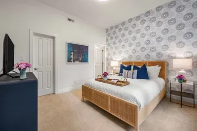 Another large bedroom is located on the lower level with a queen bed, walk-in closet, and ensuite bathroom.