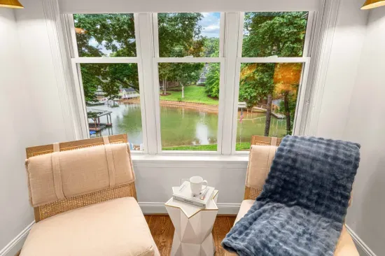 Our primary bedroom is on the main floor and features a king bed, TV, and sitting area.
