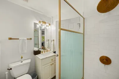 The apartment also features a full bathroom with a walk-in shower.