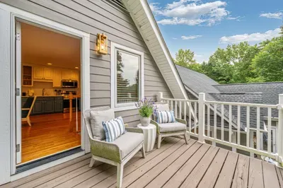 Walking out the apartment door leads to a small deck overlooking the property.