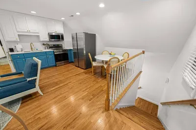 In the garage there is an entrance to an upstairs apartment that sits over the garage area.