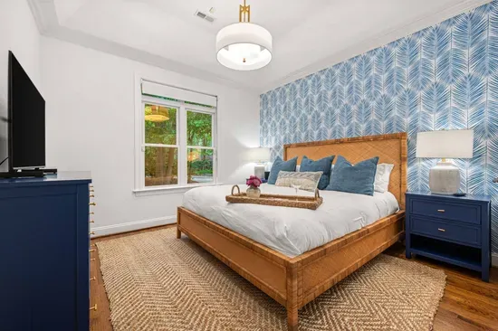 Also on the main floor is a beautiful secondary bedroom with a king bed and a television.  Guests in this room will share the primary bathroom.