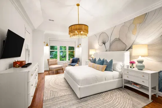 Our primary bedroom is on the main floor and features a king bed, TV, and sitting area.