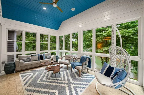Relax in our sunroom and take in the beautiful view of the lake and the property.