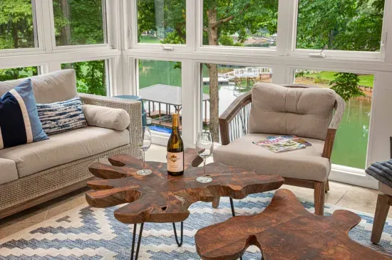 Relax in our sunroom and take in the beautiful view of the lake and the property.