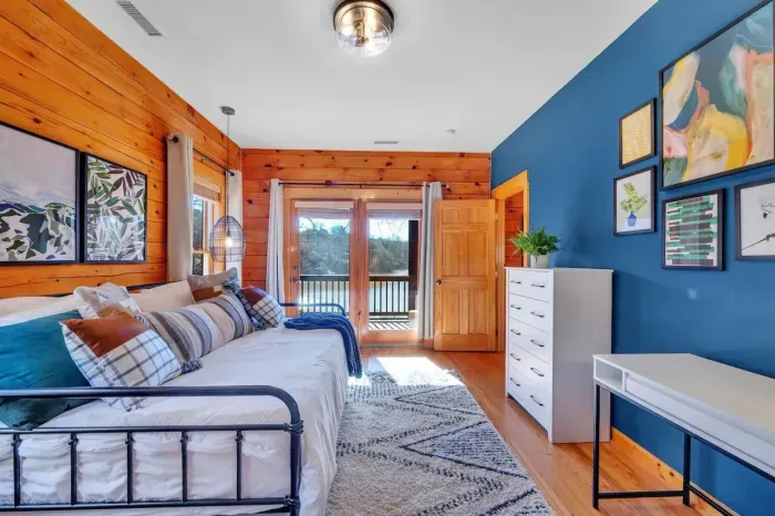 Upstairs 2nd bedroom which also features a dresser and desk made for some concentrated work (when needed) with the lake behind you.