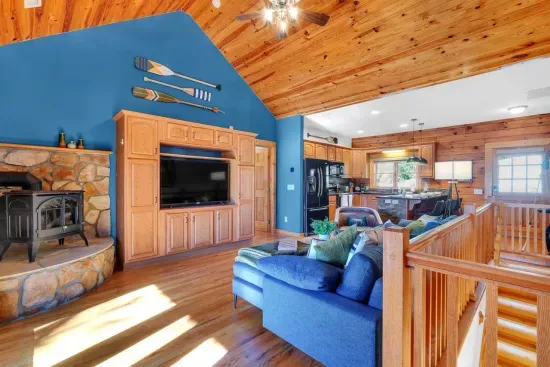 Upstairs living room with gas space heater, 55" LCD TV, board games and a view to the lake.