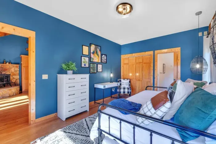 Upstairs 2nd bedroom which also features a dresser and desk made for some concentrated work (when needed) with the lake behind you.