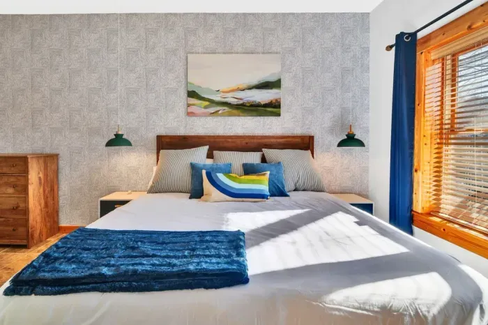 Downstairs primary bedroom with dresser and nightstands.