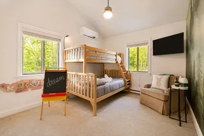 Bunk beds and a cozy
reading chair welcome
little cabin adventurers.