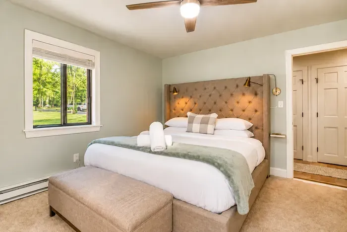 Sage green tones and garden views make this room a retreat.
