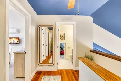 Hallway light spills into every room from the warm wood accented corridor.