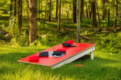 Challenge the crew to a
sunny round of cornhole at
the forest's edge.