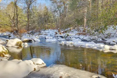 Pocono Pines vacation rental near Lake Naomi with private creek running through the wooded backyard