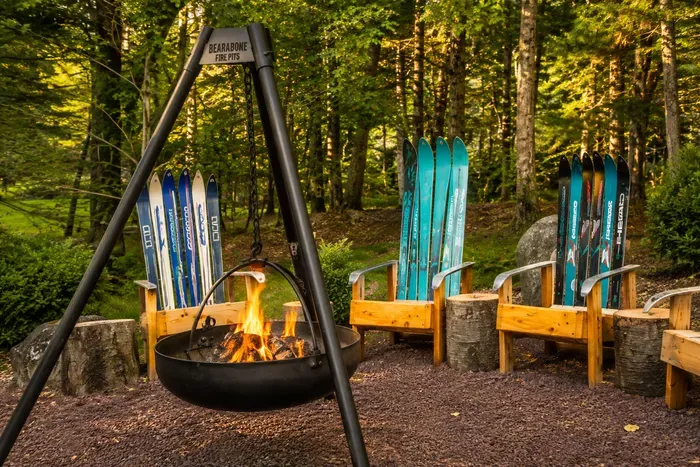 Pull up a colourful chair
and let the fire crackle
beneath the pines.