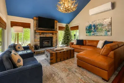 Gather by the stone
fireplace for cozy movie
nights with forest views.