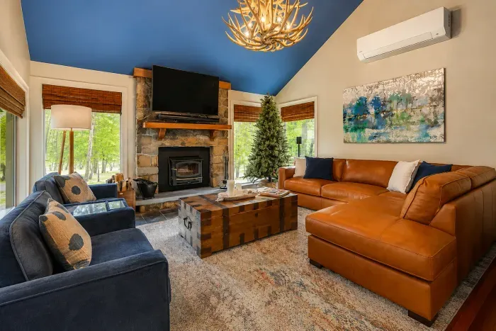 Gather by the stone
fireplace for cozy movie
nights with forest views.