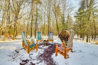 Outdoor firepit with custom-made chairs out of skis.  Stream is located behind.