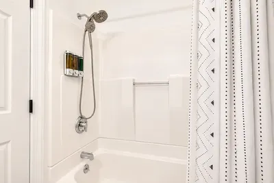 Tub/shower combo, simple and spotless for rinsing off or bathing.