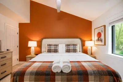 Rust tones, cozy plaid, and
soft linens create a warm
cabin welcome.