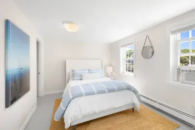 Upstairs comfort awaits! Second-floor queen bedroom features its own AC window unit, ensuring a cool retreat.