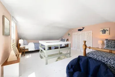 The loft offers versatile sleeping options, featuring two comfortable twin beds and one full bed. Note you access through the King bedroom to this area.