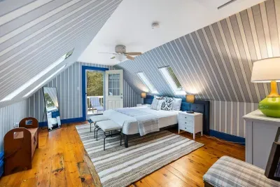 Secondary bedroom featuring queen bed & balcony with sun loungers